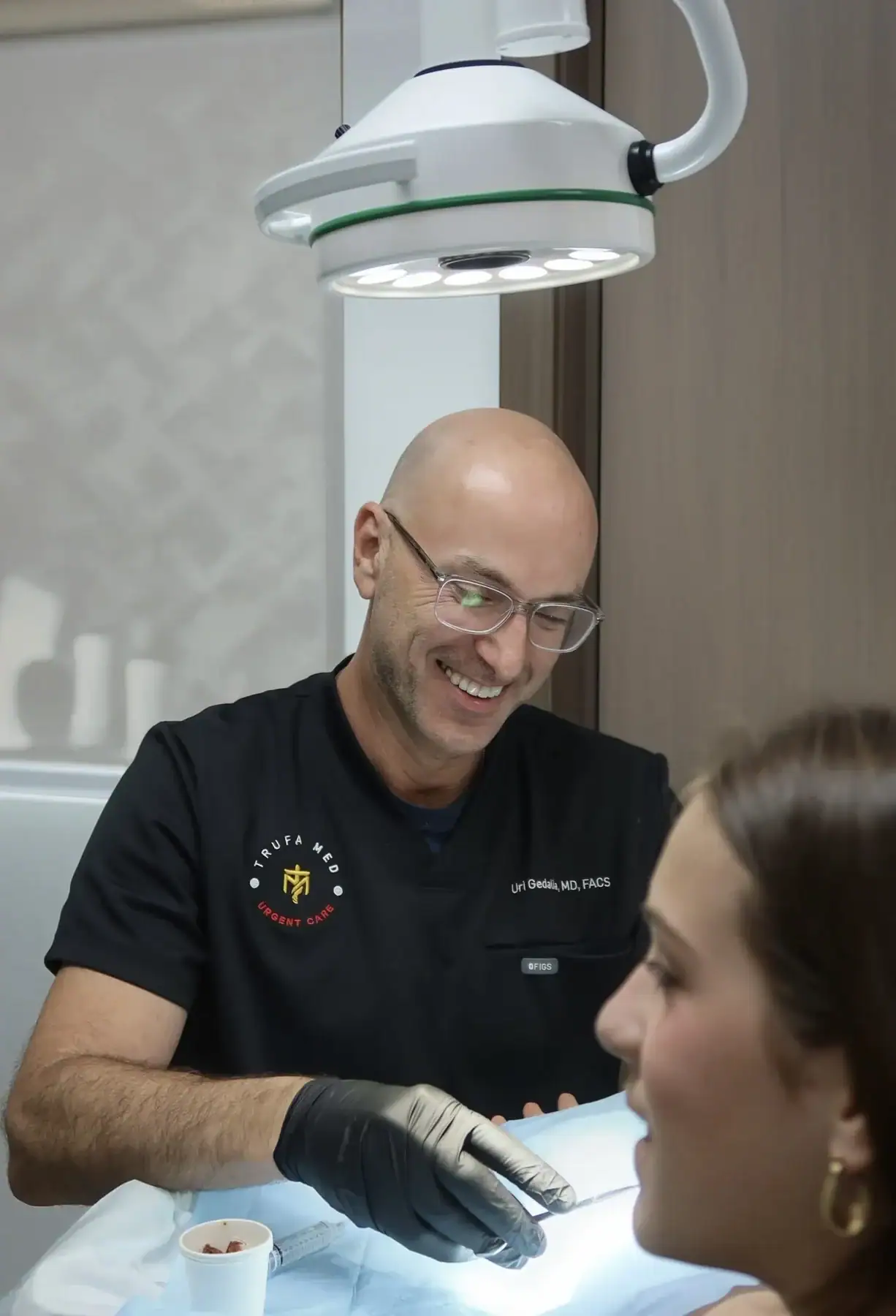 Dr. Uri Gedalia, board-certified surgeon, treating a patient at TrufaMED in Surfside, Miami